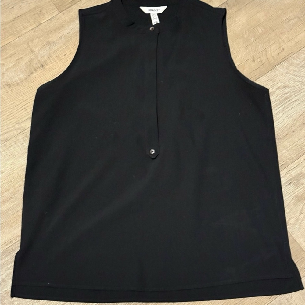 Sleeveless black top with button detail. Great for the office.